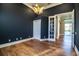 Bright home office with hardwood floors, closet, an elegant light fixture, and door to living area at 942 Hanover Way, Lakeland, FL 33813
