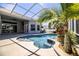 Sparkling pool with sun-shelf, water fountain, and mature landscaping in screened-in patio at 942 Hanover Way, Lakeland, FL 33813