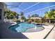 A serene pool area is surrounded by tropical foliage and offers a refreshing escape at 942 Hanover Way, Lakeland, FL 33813