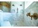 Beautiful marble tiled shower features dual heads, built-in niches and a convenient bench at 942 Hanover Way, Lakeland, FL 33813