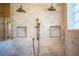 This luxurious shower shows a dual shower head system and marble tile for a spa-like experience at 942 Hanover Way, Lakeland, FL 33813