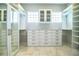 Custom walk-in closet with a window, plenty of hanging space, drawers, and mirrored doors at 942 Hanover Way, Lakeland, FL 33813