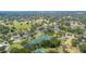 An aerial view of a quiet neighborhood featuring lush greenery and a beautiful pond at 1104 Kells Ct, Lakeland, FL 33813