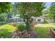 Lush backyard featuring a pool with a screen enclosure, established landscaping and serene outdoor ambiance at 1104 Kells Ct, Lakeland, FL 33813