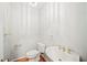 Bathroom features a modern vanity with gold fixtures and wood look flooring at 1104 Kells Ct, Lakeland, FL 33813