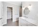 Bathroom with walk-in closet, granite countertops, and modern fixtures at 1104 Kells Ct, Lakeland, FL 33813