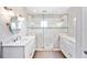 Beautifully renovated bathroom with double vanity, granite countertop, and walk-in shower at 1104 Kells Ct, Lakeland, FL 33813