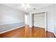 Empty bedroom with wood floors, ceiling fan, wainscotting and closet with shelving at 1104 Kells Ct, Lakeland, FL 33813