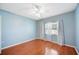 Bedroom with wood floors, blue paint, and large windows at 1104 Kells Ct, Lakeland, FL 33813