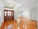 Bright foyer showcasing gleaming hardwood floors, a decorative chandelier, and a glimpse into the living spaces at 1104 Kells Ct, Lakeland, FL 33813