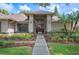 Beautiful home with a well-manicured front yard and an elegant entrance featuring a wooden door at 1104 Kells Ct, Lakeland, FL 33813