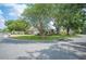 A lush green corner lot featuring mature trees and landscaping at 1104 Kells Ct, Lakeland, FL 33813