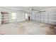 Spacious garage with concrete flooring, storage cabinets, and a garage door opener at 1104 Kells Ct, Lakeland, FL 33813