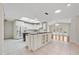 Open concept kitchen with island, tile floors, stainless steel appliances, and an eat-in area at 1104 Kells Ct, Lakeland, FL 33813