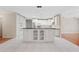 Bright kitchen featuring white cabinetry, stainless steel appliances, a center island, and a view to the pool at 1104 Kells Ct, Lakeland, FL 33813