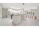 Bright kitchen featuring white cabinetry, stainless steel appliances, a center island, and a view to the pool at 1104 Kells Ct, Lakeland, FL 33813