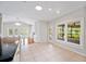 Kitchen and eat-in area with tile floors, view to living room with French doors to pool at 1104 Kells Ct, Lakeland, FL 33813