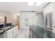 Modern kitchen has stainless appliances, double ovens, and granite countertops at 1104 Kells Ct, Lakeland, FL 33813