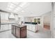 Open kitchen has center island, granite counters, and ample cabinet storage at 1104 Kells Ct, Lakeland, FL 33813