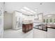 Bright kitchen with stainless steel refrigerator and dark wood island with light colored tiles at 1104 Kells Ct, Lakeland, FL 33813