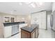 Spacious kitchen has skylight, center island, white cabinets, and stainless appliances at 1104 Kells Ct, Lakeland, FL 33813