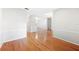 Open-concept living room with hardwood floors, white walls, and large doorways at 1104 Kells Ct, Lakeland, FL 33813