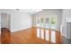 Living room featuring wood floors, white walls, and doors leading to the pool area at 1104 Kells Ct, Lakeland, FL 33813