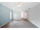 Bright living room with grey flooring, neutral paint, and modern ceiling fan at 1104 Kells Ct, Lakeland, FL 33813