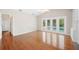 This bright living room features wood floors, a ceiling fan, and access to the pool area at 1104 Kells Ct, Lakeland, FL 33813