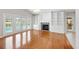 Bright living room with wood floors, fireplace, built-ins, and French doors to the pool at 1104 Kells Ct, Lakeland, FL 33813