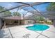 The private screened-in pool offers a refreshing retreat with ample patio space for outdoor lounging and entertaining at 1104 Kells Ct, Lakeland, FL 33813