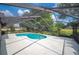 A screened-in pool area, perfect for outdoor relaxation, featuring a pristine, inviting pool surrounded by lush greenery at 1104 Kells Ct, Lakeland, FL 33813