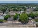 Aerial view shows a cozy home nestled in lush greenery, in a well-maintained residential neighborhood at 1720 Kendrick Ln, Lakeland, FL 33805