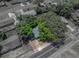 Overhead view of the home shows privacy and landscaping with mature trees and quaint fenced backyard at 1720 Kendrick Ln, Lakeland, FL 33805