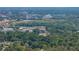 Scenic aerial view of the city shows multiple buildings, an expanse of green space, and a lush tree canopy at 1720 Kendrick Ln, Lakeland, FL 33805