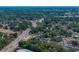 This aerial view shows a neighborhood of cozy homes nestled among lush trees at 1720 Kendrick Ln, Lakeland, FL 33805