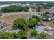 This aerial view showcases a charming home with mature trees in a desirable neighborhood at 1720 Kendrick Ln, Lakeland, FL 33805