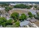 Aerial view of the neighborhood featuring the property with mature trees and green spaces at 1720 Kendrick Ln, Lakeland, FL 33805