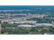 Aerial view showcases the highway, commercial buildings, and urban landscape, set against a backdrop of distant water at 1720 Kendrick Ln, Lakeland, FL 33805