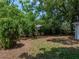 View of the backyard featuring mature trees and partial fence at 1720 Kendrick Ln, Lakeland, FL 33805