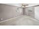 An empty bedroom with a ceiling fan and two windows at 1720 Kendrick Ln, Lakeland, FL 33805
