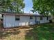 Side exterior view of the home featuring white siding at 1720 Kendrick Ln, Lakeland, FL 33805
