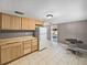 Kitchen showcasing wooden cabinets, laminate countertops, white appliances, and tile flooring at 1720 Kendrick Ln, Lakeland, FL 33805