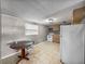 Functional kitchen with white appliances, wood cabinets, tile flooring, and adjacent dining area at 1720 Kendrick Ln, Lakeland, FL 33805