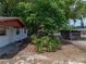 Home exterior with mature trees, landscaping, and partial fencing at 1720 Kendrick Ln, Lakeland, FL 33805