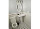 Bathroom featuring classic pedestal sink and toilet with black-and-white tile flooring at 1920 E Edgewood Dr # T6, Lakeland, FL 33803