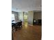 Dining room leading to a kitchen and living area with hardwood flooring at 1920 E Edgewood Dr # T6, Lakeland, FL 33803
