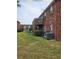 Brick apartment building with a wooden deck, lush green lawn, and a glimpse of neighboring buildings at 1920 E Edgewood Dr # T6, Lakeland, FL 33803