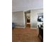 Hallway with hardwood flooring leading to a living space with a fireplace at 1920 E Edgewood Dr # T6, Lakeland, FL 33803