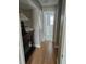 Hallway with wood floors leading to a bath and bedroom at 1920 E Edgewood Dr # T6, Lakeland, FL 33803